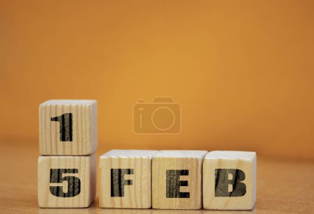 Foto de Cube shape calendar for february 15 on wooden surface with empty space for text, new year Wooden calendar with date, February cube calendar on wooden surface with copy space. - Imagen libre de derechos