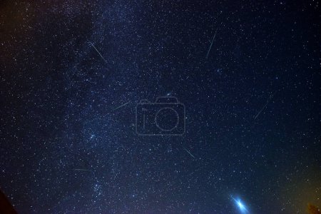 Photo for TUHINJ VALLEY, SLOVENIA - AUGUST 12, 2023: Perseid meteor shower, seen on the evening sky from Tuhinj valley in Slovenia - Royalty Free Image
