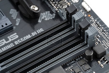 Photo for 2023.04.10 Dnipro, Ukraine: Closeup on empty RAM slots on a modern black silver motherboard. Ddr4, ddr5 memory stick slots. Macro electronics shot, technology, pc components. Shallow depth of field. - Royalty Free Image