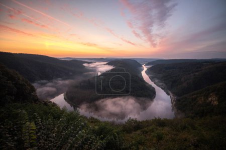 Photo for Aerial drone view of foggy morning at Saarschleife river loop in Saarland, Germany. - Royalty Free Image