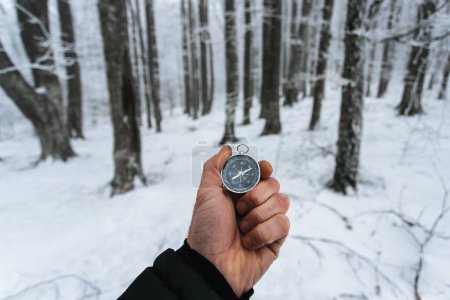 Photo for Man holding compass in hand - Royalty Free Image