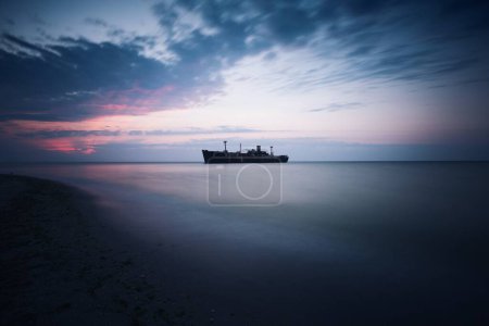 Photo for Long exposure of a ship in black sea. Morning calm sunrise wallpaper - Royalty Free Image