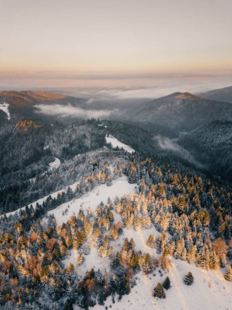Téléchargez les photos : Moody aerial drone idyllic winter landscape in sunrise. View from the top of the mountain. Hipster, vintage, abstract style - en image libre de droit