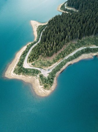Photo for Winding road, green forest and blue lake from above - Royalty Free Image