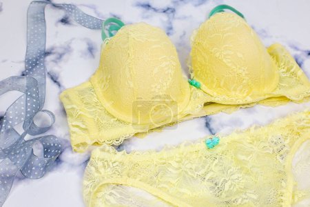 Photo for Cute pretty sexy lace yellow lingerie with blue ribbon on white background, woman shopping and fashion female wardrobe, self care concept, Woman accessories. Gift presents copy space - Royalty Free Image