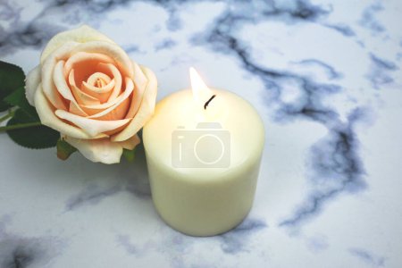Orange old rose and white soy wax candle flame, creating aroma therapy sensory , good vibes atmosphere enviroment, home decoration, rituals and spells, relaxation and peaceful moment. spa healing.