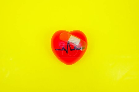 Photo for Pulsing heart, heartbeat with Band-Aid symbolise as heart diseases, heart health, unhealthy heart conditions, heart problems, education and heart health awareness risks. - Royalty Free Image