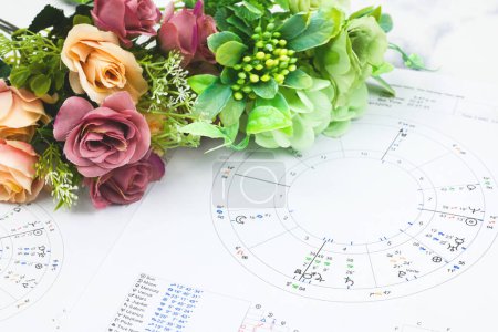 Photo for Printed astrology birth chart and white roses, workplace of astrology, spiritual, The callings, hobbies and passion, blueprints and life mapping - Royalty Free Image