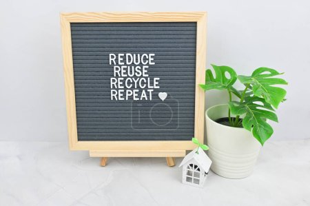 Foto de Letter board with quote Reduce Reuse Recycle, repeat. House model with tree, save the planet. Environmental sustainable eco friendly, Zero waste healthy lifestyle concept - Imagen libre de derechos