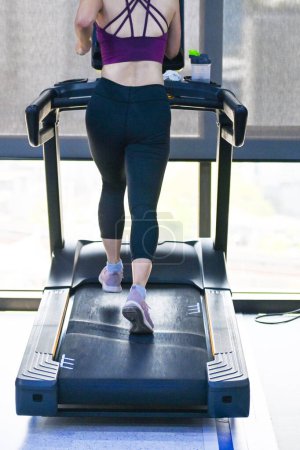Photo for Young sport woman sweat running on treadmill in gym, Self care time by work out exercise, mindfulness lifestyle - Royalty Free Image