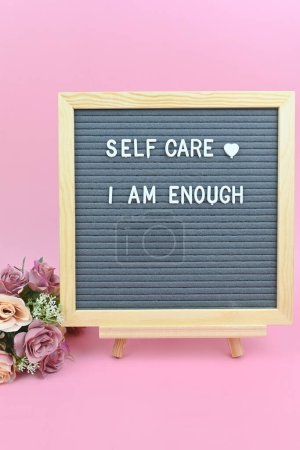 Foto de Grey letter board with phrase Self care I am enough. Self love, Mindfulness lifestyle, mental health. Aspiration, affirmative and supportive sentence. - Imagen libre de derechos