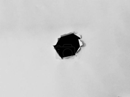 Photo for Paper frame with the ripped holes. a black hole on the white paper. for copy space background overlay - Royalty Free Image