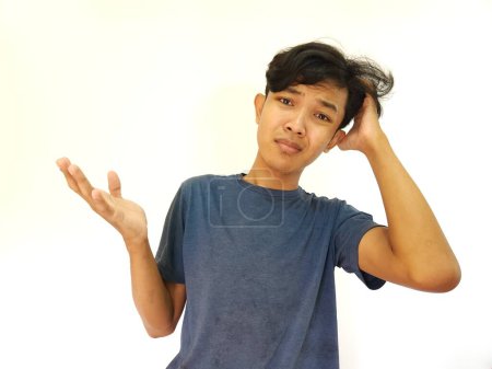 Photo for Asian man scratching hair with confused and clueless face - Royalty Free Image