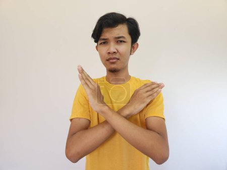 Photo for Portrait of young handsome Asian man showing STOP or Rejection expression crossing arms doing negative sign, angry face, isolated blue color background - Royalty Free Image