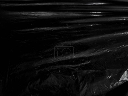 Photo for Black transparent plastic wrap texture overlay background. Realistic plastic for poster design and photo overlay effect. Wrinkled plastic surface pattern for graphic design sources and element. - Royalty Free Image