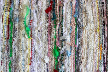 Photo for Woven fabric. Fabric from textile waste. Fabric woven on a loom. Cloth woven from linen, hemp, cotton, silk, woolen strips of fabric - Royalty Free Image