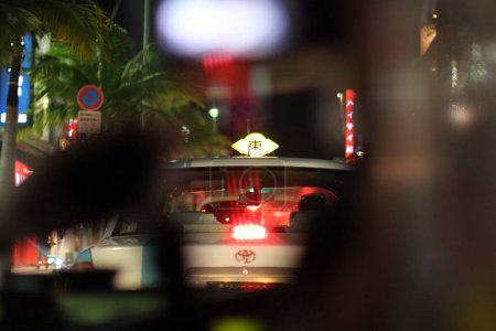Photo for Taxi Sign in Japan Taken from a vehicle behind, night city life - Royalty Free Image