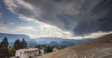 Photo for Stormy clouds over town and hills - Royalty Free Image