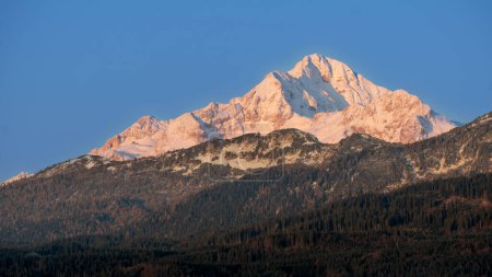 Photo for Mt. Triglav, the highest peak in Slovenia, captured at sunrise on an autumn day, with the higher regions already covered in snow - Royalty Free Image