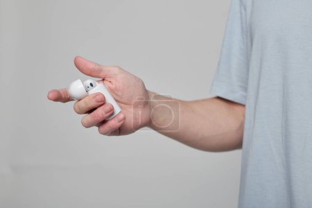 Foto de Primer plano de las manos de un extraño sosteniendo un auricular portátil - Imagen libre de derechos