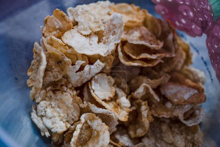 A container of emping crackers to be used as toppings for soto