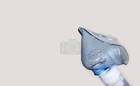 Photo for Woman using inhaler nebulizer for respiratory diseases treatment concept,physiological solution salted water.unrecognizable female isolated light background.inhalation at home free space copy paste - Royalty Free Image