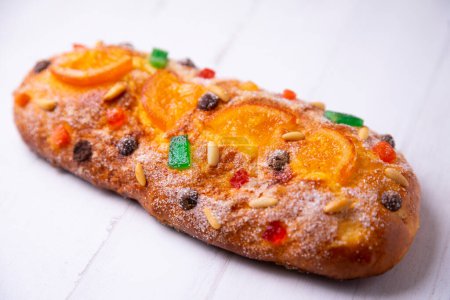 Photo for Coca de sant joan. Traditional San Juan cake to celebrate the arrival of summer in Spain made with brioche bread, candied fruit and nuts. - Royalty Free Image