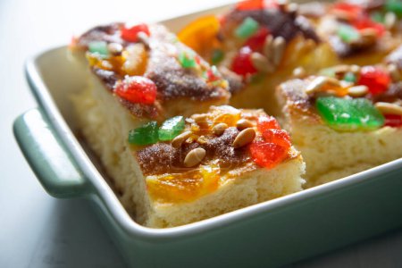 Photo for Coca de sant joan. Traditional San Juan cake to celebrate the arrival of summer in Spain made with brioche bread, candied fruit and nuts. - Royalty Free Image