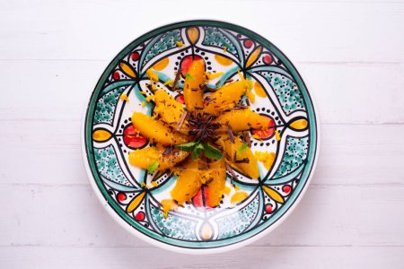 Photo for Spiced oranges with cloves and cinnamon served with organic honey and grated chocolate. - Royalty Free Image