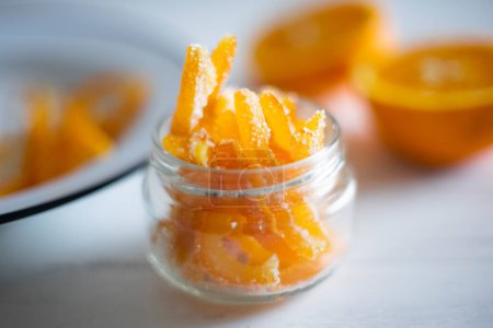 Foto de Candied orange sticks in sugar served in a glass. - Imagen libre de derechos