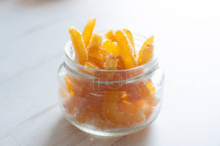 Foto de Candied orange sticks in sugar served in a glass. - Imagen libre de derechos