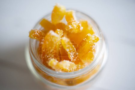 Téléchargez les photos : Candied orange sticks in sugar served in a glass. - en image libre de droit