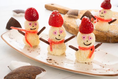 Photo for Snowmen made with white chocolate and coconut bonbons. - Royalty Free Image