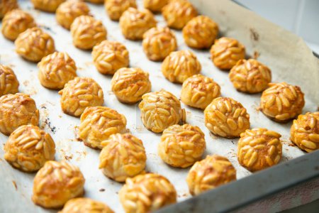 Photo for Penellets. Small sweets of various shapes, made from almond and potato dough, and covered with almonds or pine nuts. - Royalty Free Image