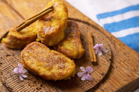 Foto de The torrija or torreja, also called French toast, is a dish made from a slice of bread that is soaked in milk, syrup or wine and, after being coated in egg, is fried in a pan with oil. - Imagen libre de derechos