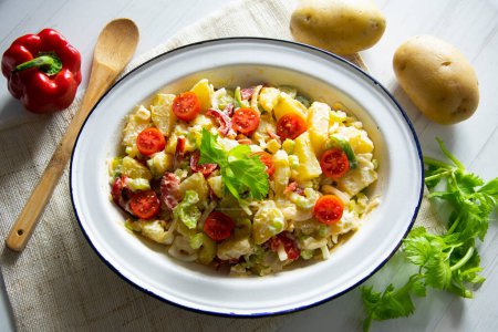 Photo for Potato salad, celery, cherry tomatoes and mayonnaise. - Royalty Free Image
