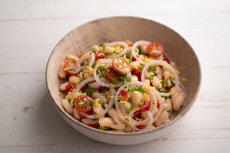 Photo for White bean salad with onion and tomato. - Royalty Free Image