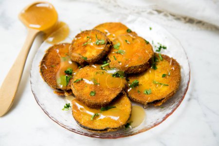 Photo for Fried breaded eggplant slices covered with honey. - Royalty Free Image