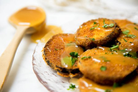 Photo for Fried breaded eggplant slices covered with honey. - Royalty Free Image