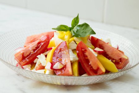 Photo for Delicious salad with mango and tomatoes. - Royalty Free Image