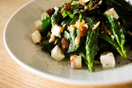 Photo for Spinach salad with cheese and nuts. - Royalty Free Image