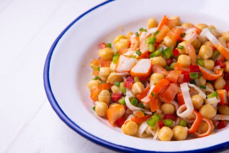 Photo for Delicious and healthy chickpea salad with crab surimi. - Royalty Free Image