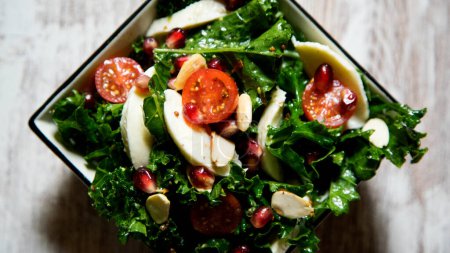 Photo for Delicious and healthy kale salad, mozzarella cheese and cherry tomatoes. - Royalty Free Image