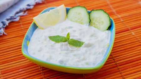 Photo for Tzatziki, the Greek version of cack, is a cucumber and yogurt-based sauce, consumed in many dishes, especially meat. - Royalty Free Image