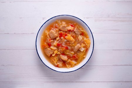 Photo for Menorcan soup with peppers, cabbage and tomato with slices of bread. - Royalty Free Image