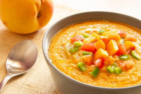 Photo for Peach Gazpacho is a cold soup with various ingredients such as olive oil, vinegar, water, raw vegetables, usually tomatoes, cucumbers, peppers, and garlic. - Royalty Free Image