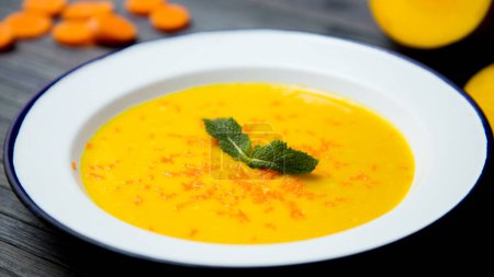 Photo for Bowl with carrot cream and vegetables. - Royalty Free Image
