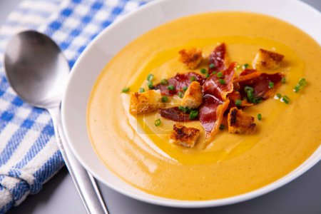 Photo for Bowl with carrot cream and iberico spanish ham. - Royalty Free Image