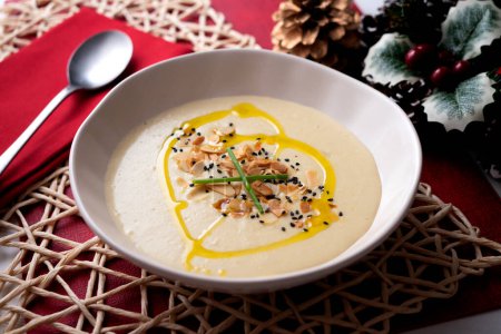 Photo for Homemade leek soup made with vegetable and potato broth. Christmas decorated table. - Royalty Free Image
