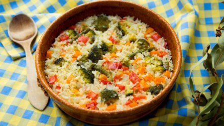 Baked rice with vegetables. Traditional Spanish paella recipe.